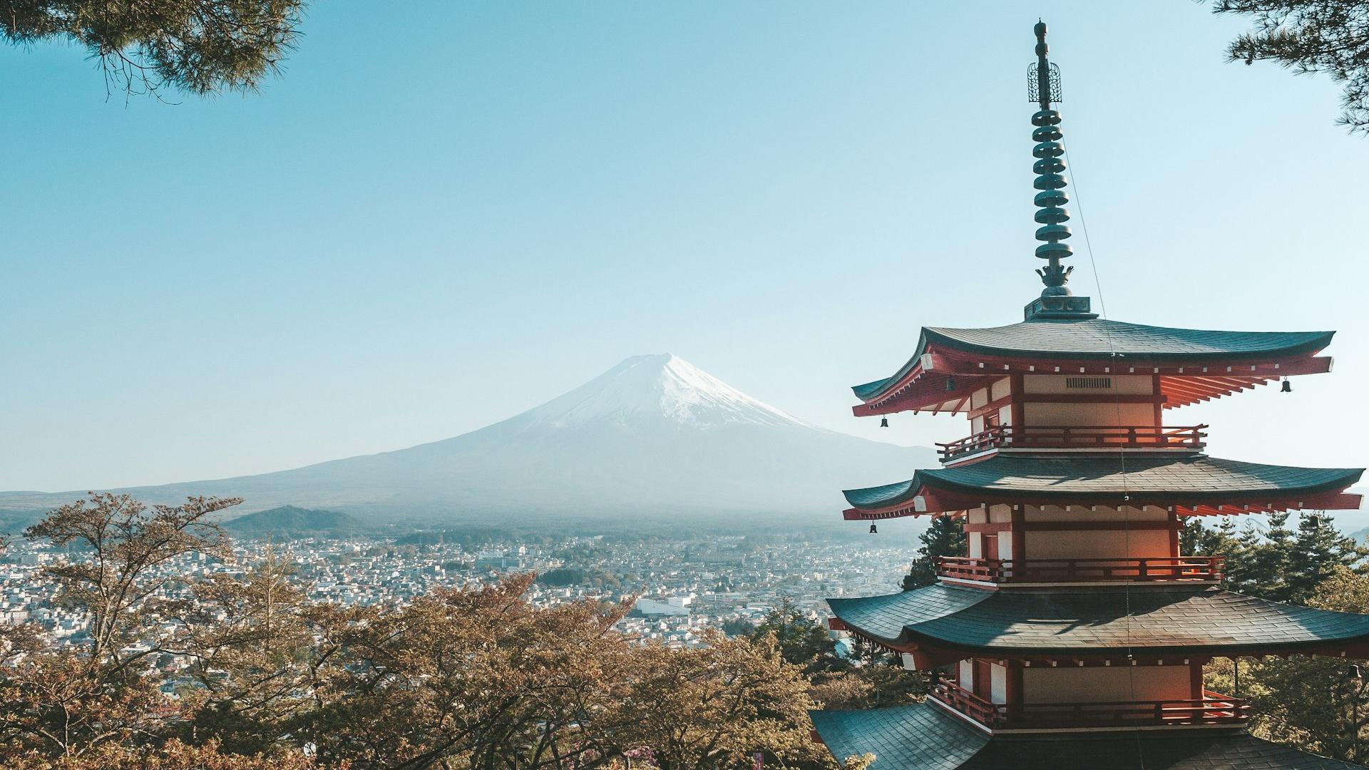 brown and white temple near body of water during daytime